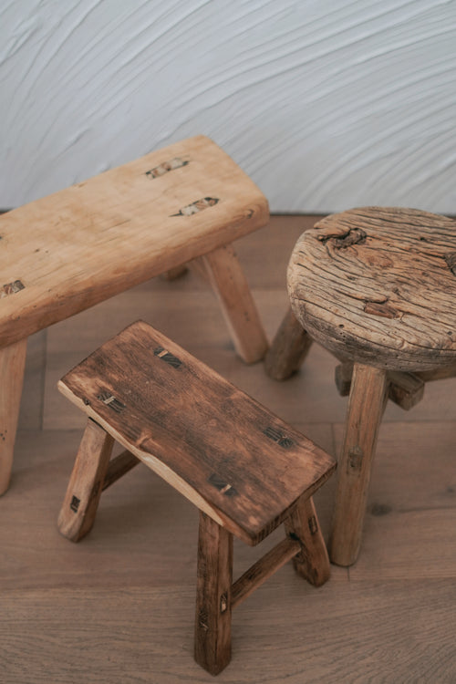 Unique Chinese vintage elm wood mini stool with a rustic, weathered finish, perfect for use as a plant stand or decorative accent.