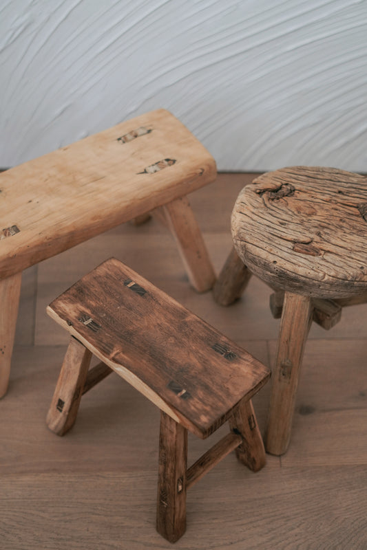 Unique Chinese vintage elm wood mini stool with a rustic, weathered finish, perfect for use as a plant stand or decorative accent.